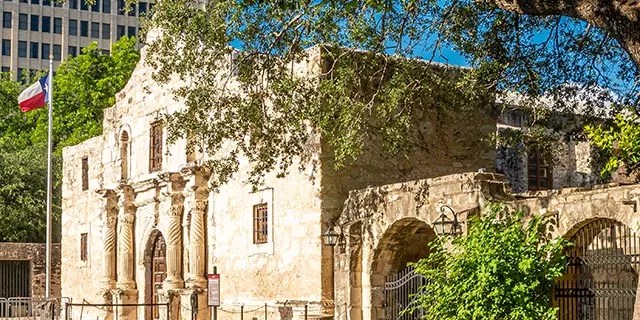 Shown here is the facade of the Alamo Mission in San Antonio, Texas. Enjoy some history at the Alamo, then stroll down the River Walk and dine at any of the romantic restaurants the city has to offer.