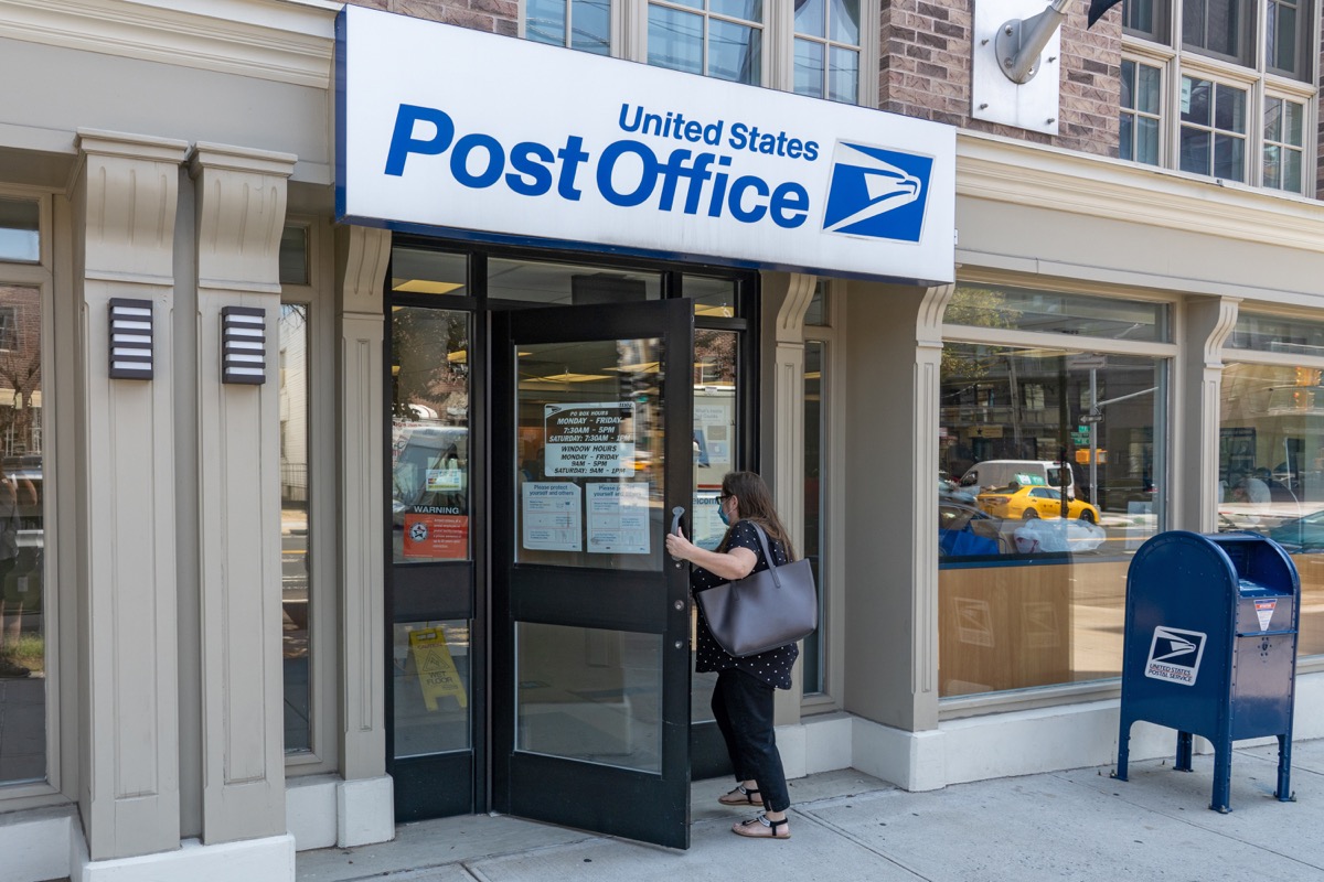 A woman enters the United States Postal Service (USPS) post office in Long Island City on August 17, 2023 in Queensboro, New York City.