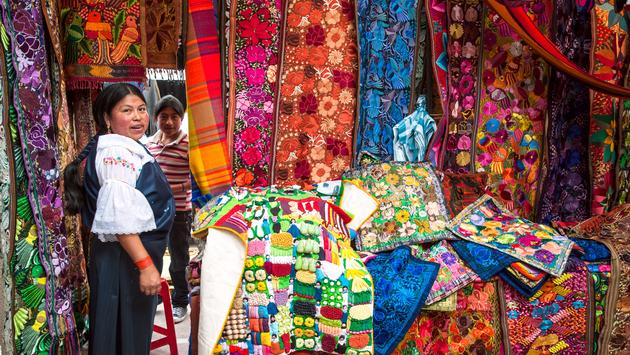 Ecuador, Otavalo Indian woman selling textile products Ecuador, Otavalo Indian woman selling textile products