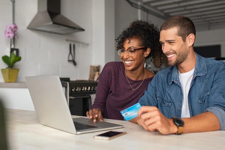 Man and woman shopping online with credit card